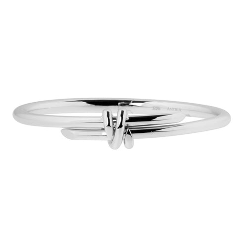 Sterling silver wrap bangle with two bands that cross at the front. They have tapered ends and bangle is hinged for easy wrist placement, ref 7387.
