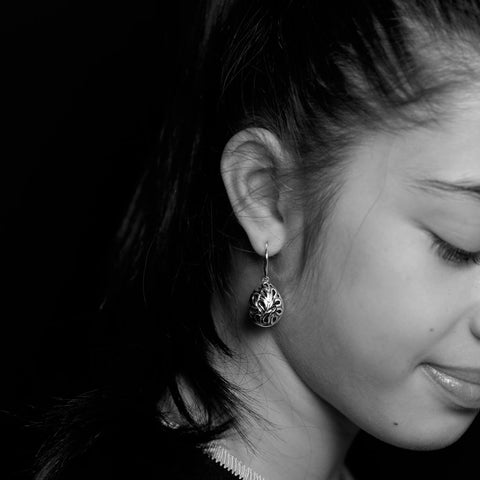 Shaku earrings are slightly bulbous, teardrop-shaped earrings in sterling silver from Antika. Slightly raised edges to cut-out design. 34mm long.