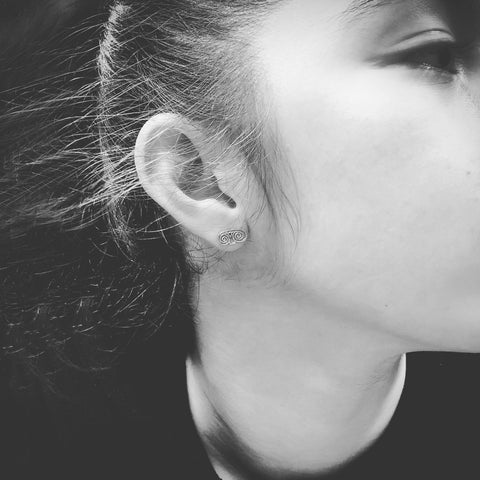 Matt and textured Sterling silver stud earrings in the shape of Antika's logo, 6 x 12mm.