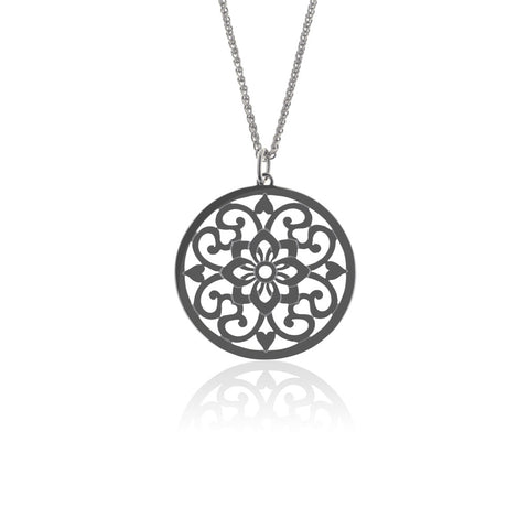 Moroccan inspired pendant from ANTIKA. The design is round with cut-out sterling silver swirls and hearts. 28mm in diameter.