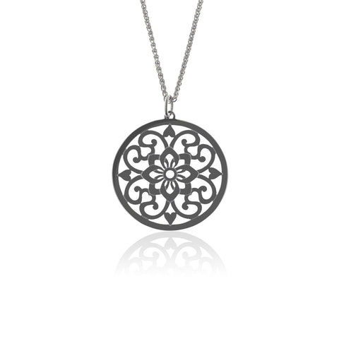 Moroccan inspired pendant from ANTIKA. The design is round with cut-out sterling silver swirls and hearts. 28mm in diameter.