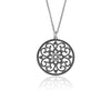 Moroccan inspired pendant from ANTIKA. The design is round with cut-out sterling silver swirls and hearts. 28mm in diameter.