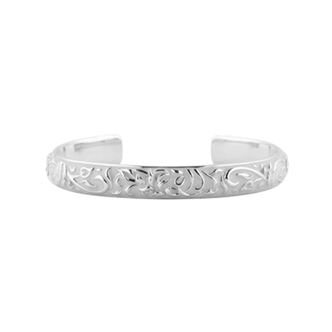 Sterling silver and ivory coloured enamel cuff bangle with a raised floral motif, 6mm wide, 65mm inner diameter.