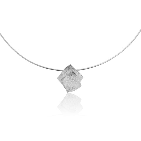 Pendant of two layered squares of silver in textured matt finish. Shown on choker.