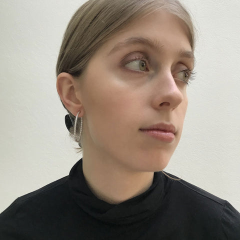 Sterling silver hoop earring 39mm in diameter, with continuous crystals down the front face of the earring that follows down the back of the inside face.