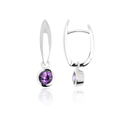 Sterling silver huggie earrings from ANTIKA with a hinged top ending with an amethyst stone in a bezel setting. They are 25mm long.
