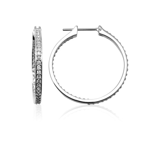 Fine, sterling silver hoop earrings with white crystals down the front face of the earring and follow down the back of the inside face of the earring.  The earrings fasten with a latch mechanism. 29mm in diameter.