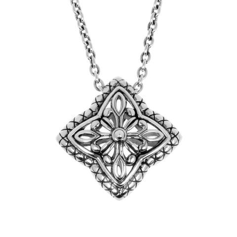 Céline necklace from ANTIKA,  features a carved sterling silver pendant with an oval-linked sterling silver chain. The front pattern is raised and builds to an apex. Necklace is 45cm long.
