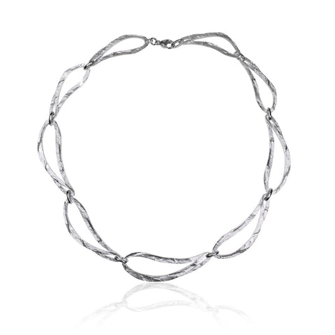 Magnificently crafted choker necklace from Antika. Flame-shaped open links in textured, matt sterling silver with a protective layer of rhodium. The necklace is 44cm long and the links are 50mm x 15mm. Wear with matching bracelet. Made in Germany.