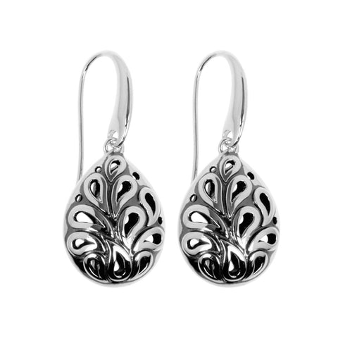 Shaku earrings are drop earrings, slightly bulbous, teardrop-shaped in sterling silver with slightly raised fluid designs front and back. 34mm long.