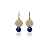 Gold plated sterling silver and lapis lazuli earrings featuring a free hanging shell fossil imprint. Stud fitting concealed. From Antika.