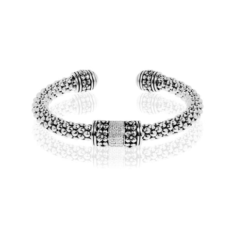 Sterling silver beaded cuff bangle with floral motifs, 57mm inner dimension.
