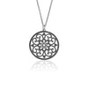 Moroccan inspired pendant from ANTIKA. The design is round with cut-out sterling silver swirls and hearts. 28mm in diameter.