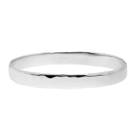 Sterling Silver Belize bangle by Antika. Oval-shaped with a near flat surface, slightly beaten finish on the outside and smooth on the inside face. Substantial weight at about 37 grams. It measures 70mm x 57mm and has a band width of 10mm wide. Never need to clean as it has a protective layer of white rhodium. High polish finish.