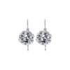 Hollow, ball-shaped earrings with cut-out wave patterns in sterling silver and studded with white cubic zirconia stones in claw settings